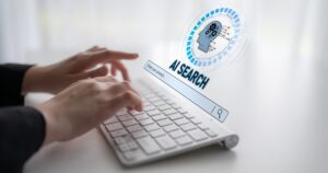 Hands typing on a keyboard with an AI-powered search interface overlay