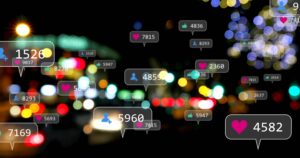 Blurred nighttime city scene with floating social media notification icons showing likes, followers, and engagement counts over colorful lights.